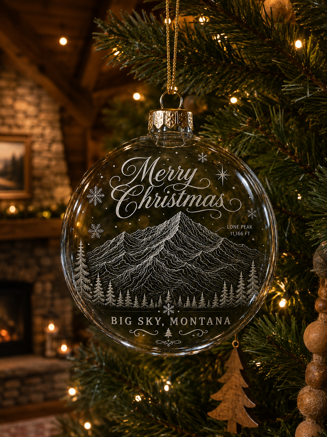 Big Sky Merry Christmas Lone Peak glass ornament on a lodge Christmas tree