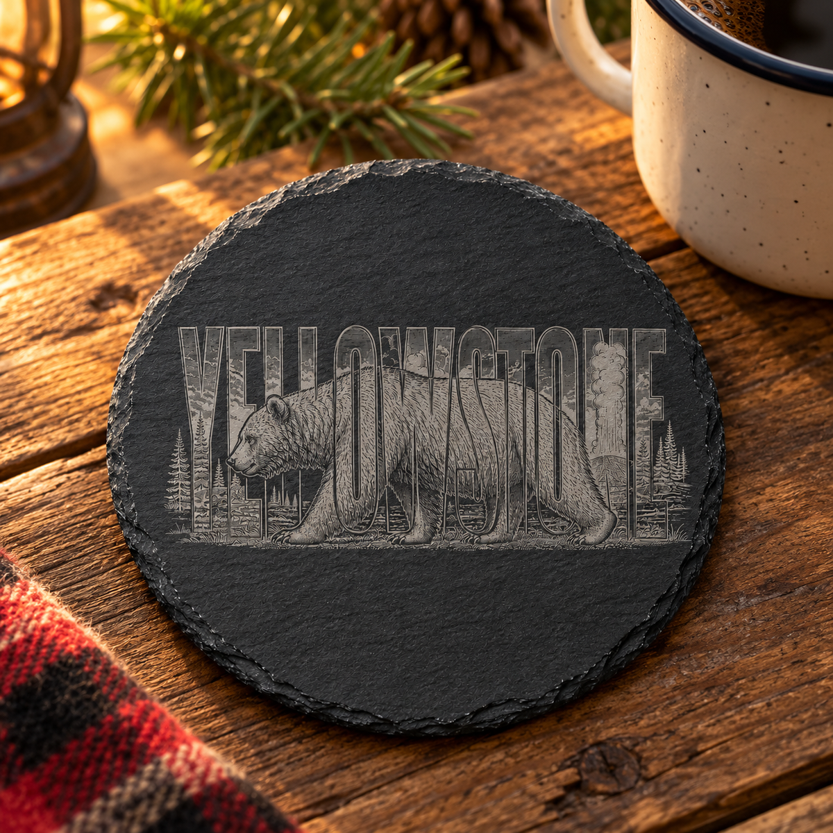Grizzly Bear Slate Coaster — lifestyle view of the engraved black slate coaster on a cabin table.