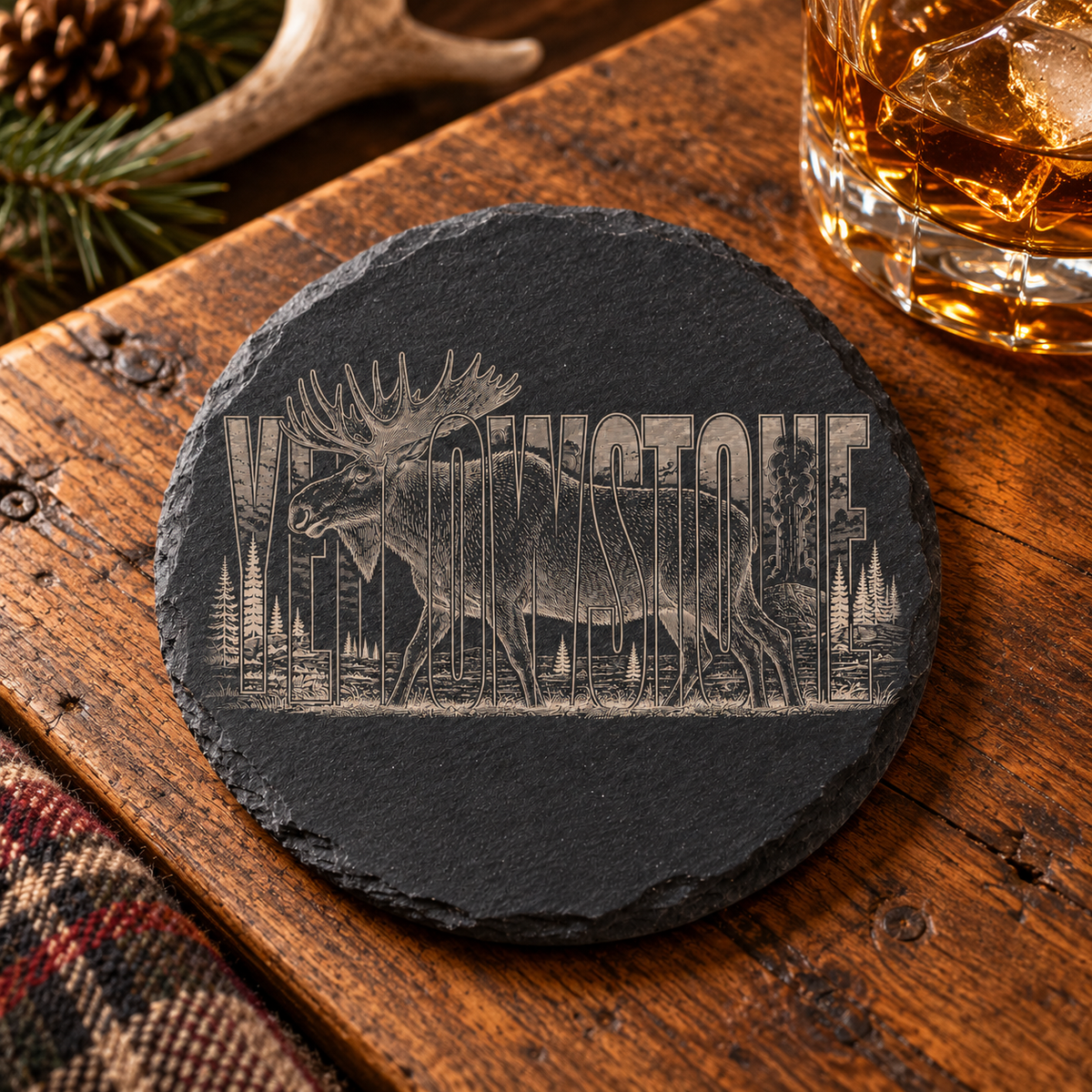 Bull Moose Slate Coaster — lifestyle view of the engraved black slate coaster on a lodge table.