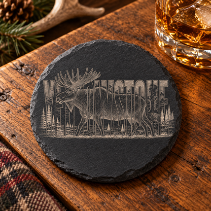 Bull Moose Slate Coaster — lifestyle view of the engraved black slate coaster on a lodge table.