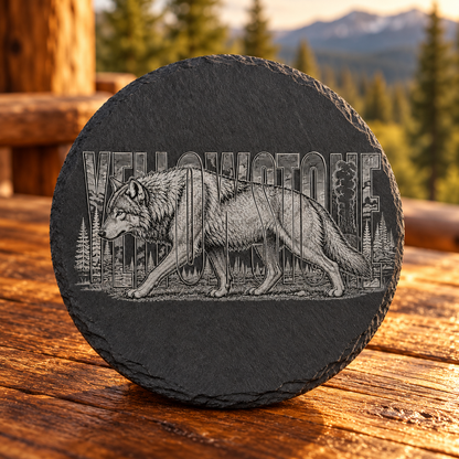 Gray Wolf Slate Coaster — lifestyle view of the engraved black slate coaster on a Montana cabin table.
