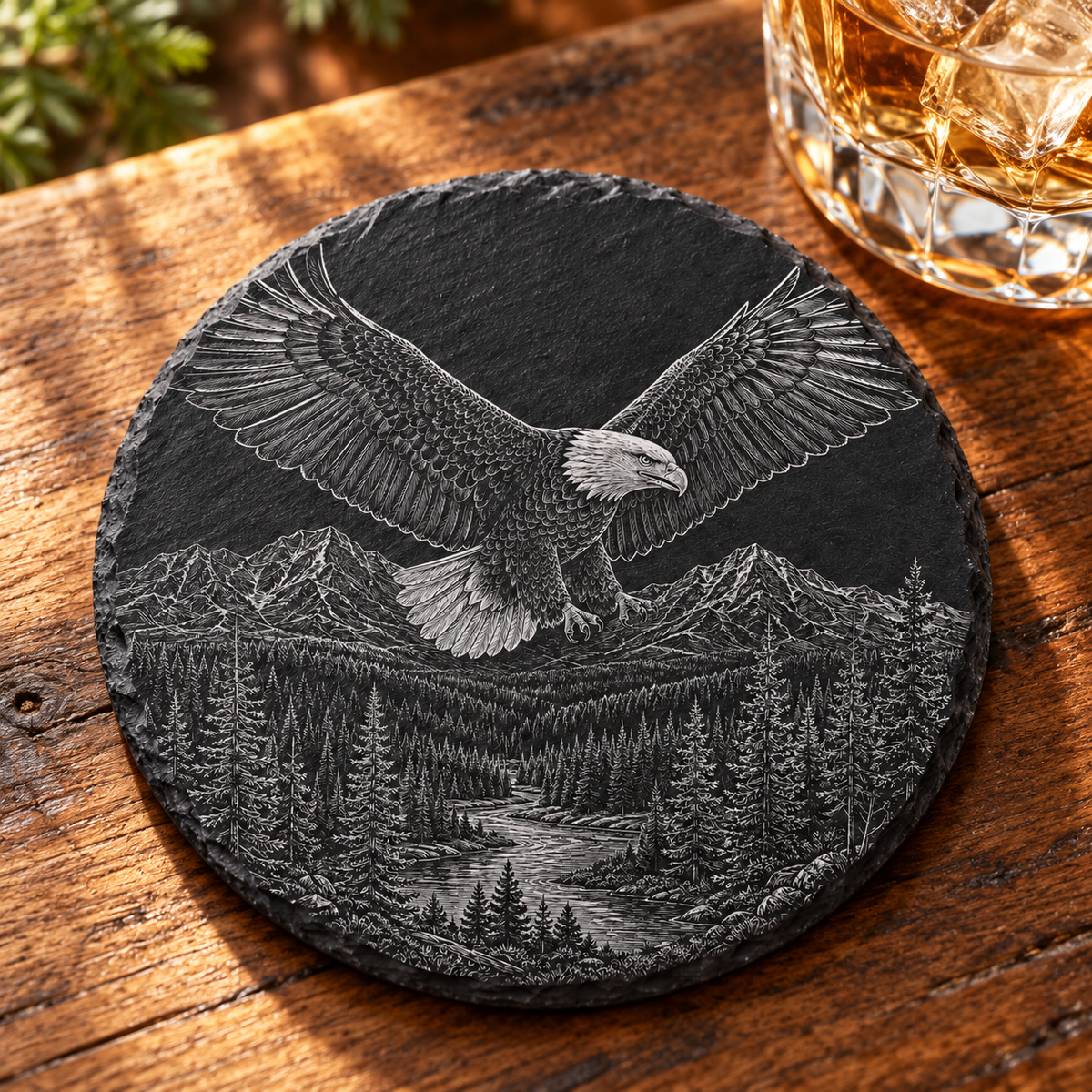 Yellowstone Bald Eagle Slate Coaster — lifestyle view of the engraved black slate coaster on a lodge table.