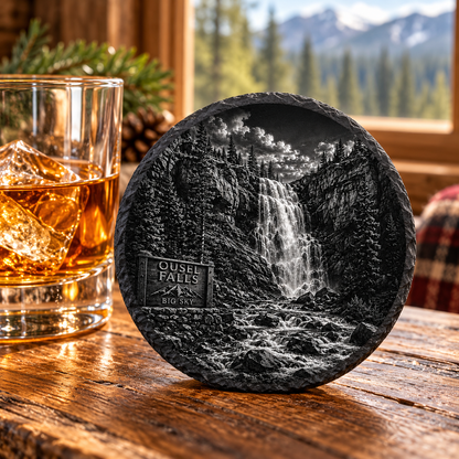 Ousel Falls Slate Coaster — lifestyle view of the engraved black slate coaster on a lodge table.