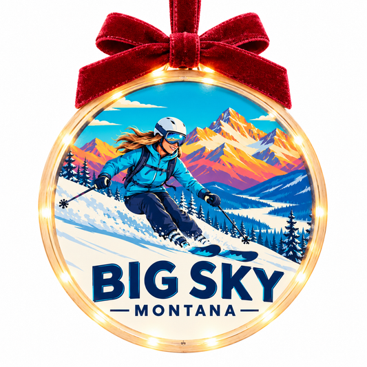 Big Sky Girl Skier ornament — clear acrylic disc, narrow pale wood rim, burgundy bow