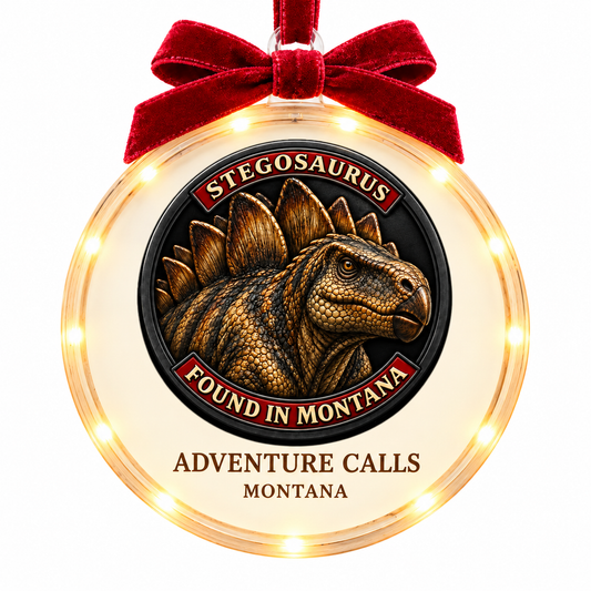 Montana Dinosaur Adventure Stegosaurus light-up ornament, approved clear disc frame, LED edge and burgundy bow